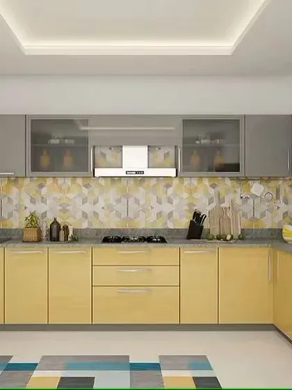 This L-shaped kitchen combines glossy yellow base cabinets with grey uppers. The geometric patterned backsplash adds a playful and modern touch.