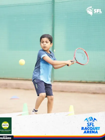 A young beginner learns to connect with the ball. Our coaching for first-timers focuses on making tennis fun and accessible while building a strong technical foundation.