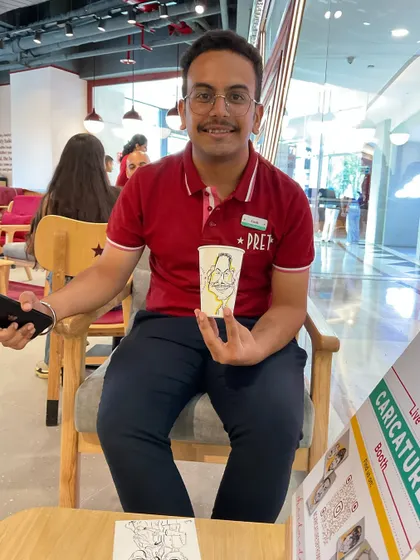 A member of the Pret staff with his own coffee cup caricature. It was fun to sketch the team too.