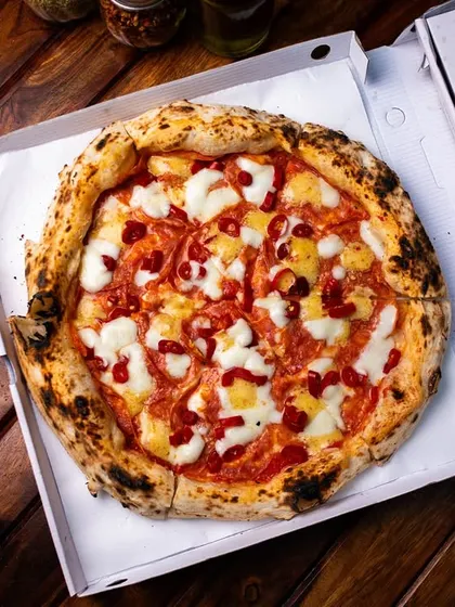 A classic mozzarella pizza, boxed up and ready for delivery from our Amar Colony outlet.