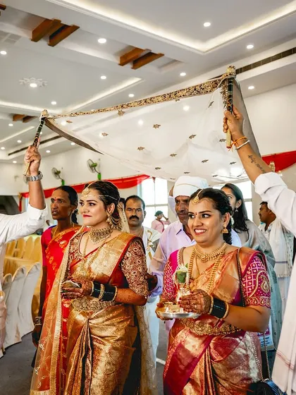 The bride making her entrance under the traditional canopy, looking serene and beautiful.
