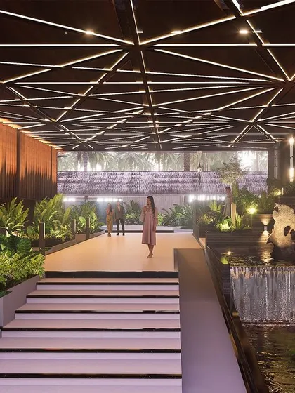 The grand lobby entrance of the Sea Front Business Hotel. A complex geometric ceiling with integrated lighting draws the eye forward, while cascading water features and lush indoor planters create a luxurious and immersive arrival experience that immediately connects guests to nature.