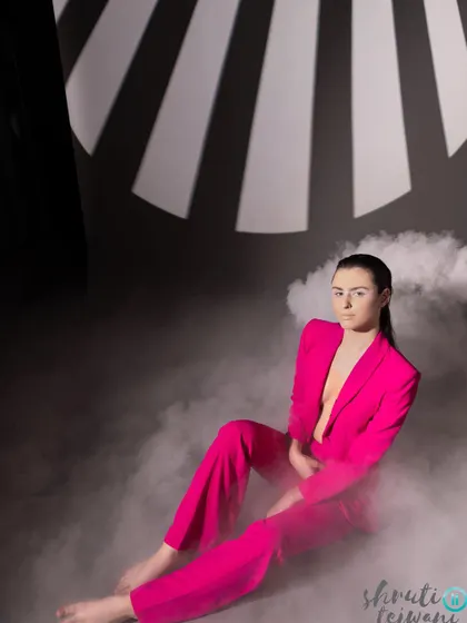 A full shot of the model in the pink suit, surrounded by smoke, creating a mysterious and captivating image for Label.san.