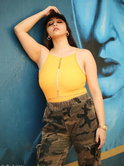 A powerful, expressive pose that showcases the model's confidence and the edgy style of the outfit.
