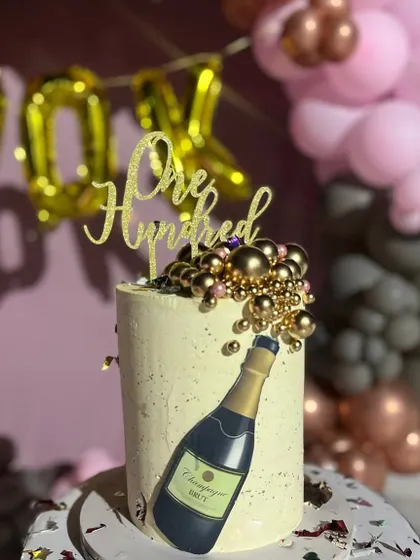 A special cake to celebrate a friend's 100k follower milestone. This design features a champagne bottle theme with sparkling gold details to mark the bubbly occasion.