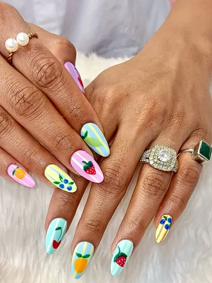 Your nails should be as fun as you are. This playful set features hand-painted strawberries, blueberries, and citrus fruits on a colorful pastel background, proving that nail art can be a total mood-booster.