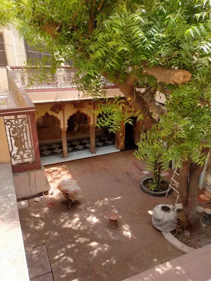 A high-angle view of the courtyard during restoration, showing the interplay of light and shadow on the half-finished surfaces.
