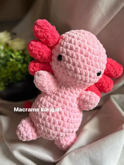 A playful pose with our pink axolotl. We love bringing these imaginative creatures to life through crochet.