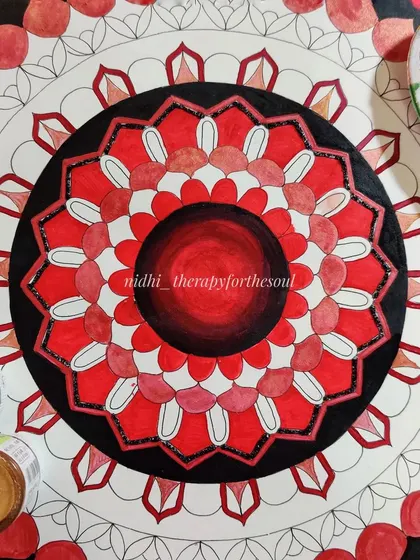 A work-in-progress shot of the 'Ruby Red' mandala. You can see the central rings are complete, with the outer layers still in their outline stage, waiting for color.
