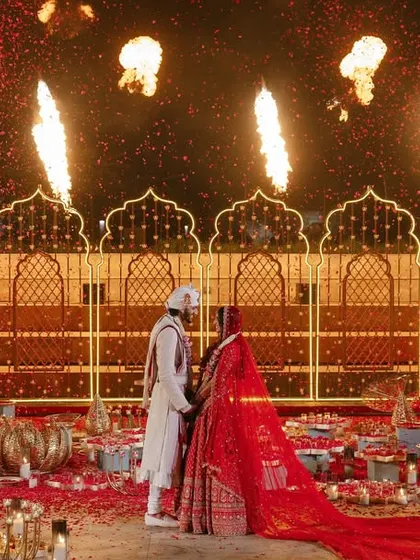 A moment of pure drama and celebration as fire effects go off behind the couple during their Varmala ceremony.