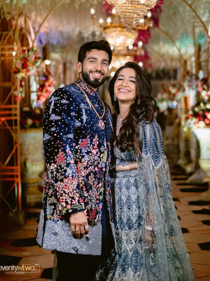 A happy couple at their reception. For the bride, I created a soft glam look with loose waves that felt romantic and modern, complementing her beautiful blue outfit.