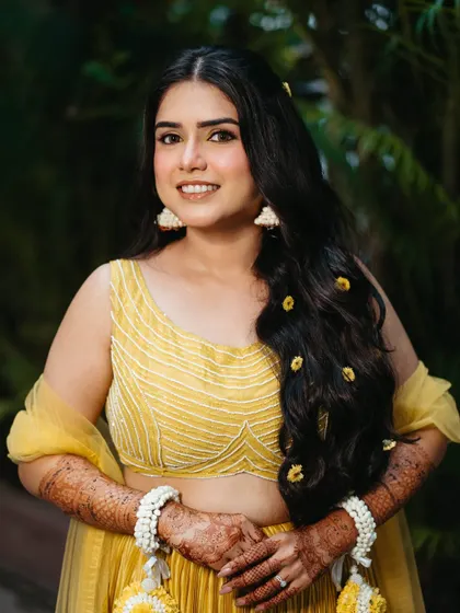 A beautiful portrait of our Haldi bride. Her skin is glowing, and her makeup is kept minimal to complement the bright yellow of her outfit.