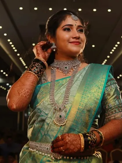 A happy client looking stunning in a layered CZ set for her reception. The intricate design and sparkling stones make her the center of attention.