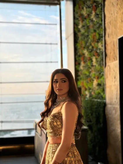 The client looks stunning against the city skyline, her wavy hair catching the golden hour light beautifully.