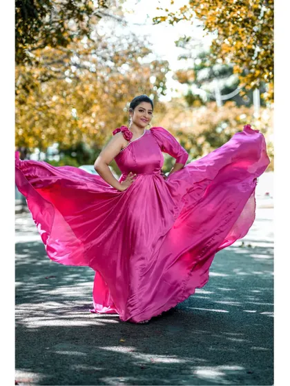 Another stunning shot of the pink satin gown in motion, showing off its beautiful flow and vibrant color.