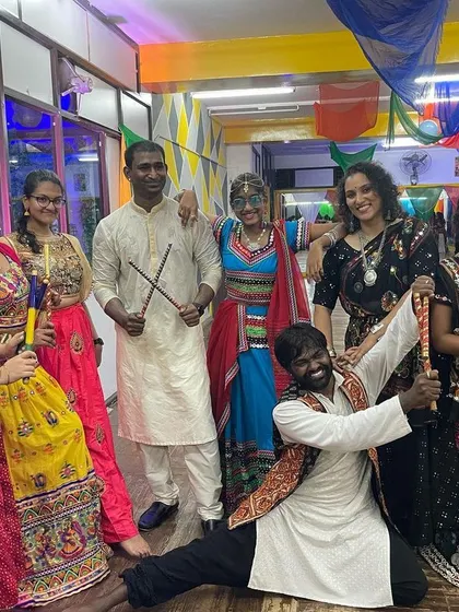 Posing with participants in their beautiful traditional attire at our Dandiya event.