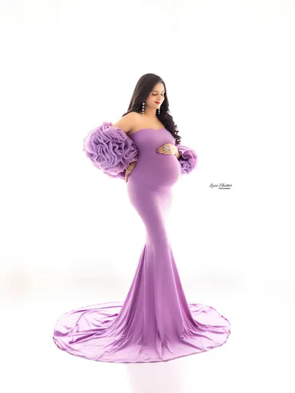 A classic full-length portrait to showcase the elegance of this lavender mermaid gown. The off-the-shoulder floral sleeves add a unique and fashionable touch.