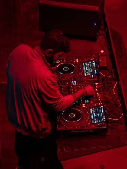 An overhead shot of me working the Pioneer decks, giving a clear view of the professional equipment I use.