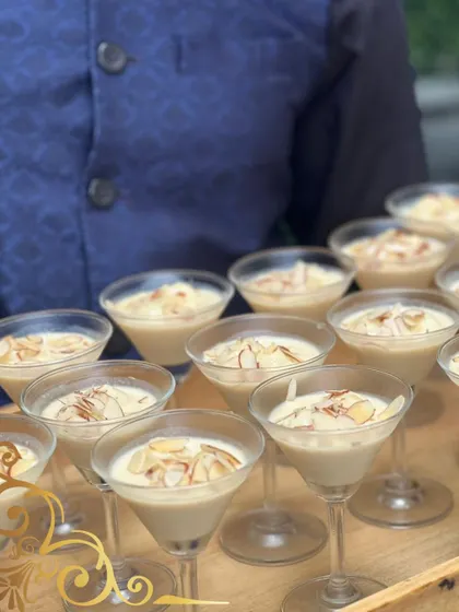 A modern take on a classic Indian dessert, possibly a rich kheer or phirni. Served in martini glasses and garnished with toasted almonds, it's both familiar and fancy.