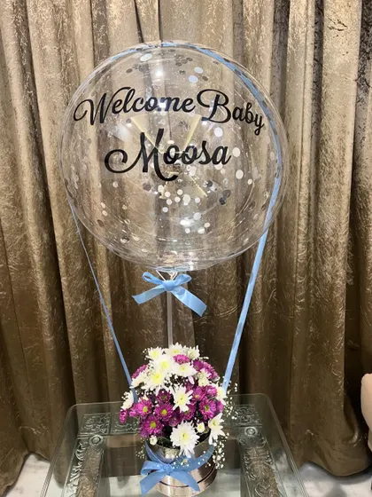 Another angle of our 'Welcome Baby Moosa' arrangement, showing how the custom script on the balloon stands out against the confetti inside.
