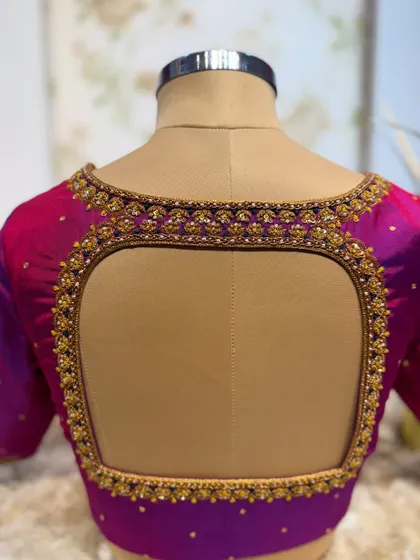 A full view of the back of the dual-tone blouse, highlighting its simple elegance and clean finish.