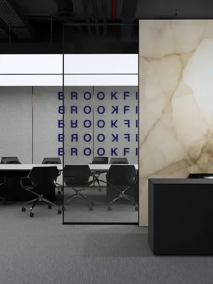 A concept for a modern meeting room where a backlit onyx-style panel provides a sophisticated backdrop. The design combines minimalist elegance with functional technology, creating a space that is both impressive and highly practical for corporate interactions.