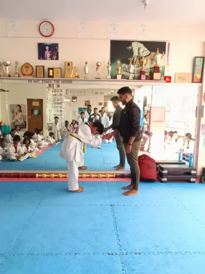 A bow of respect after receiving a yellow and green belt.