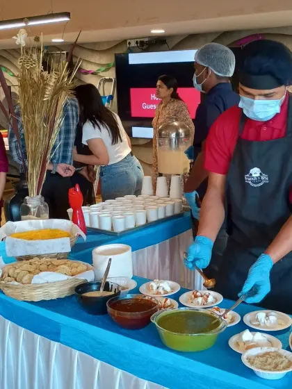 Our live chaat counter is always a hit at corporate family days and celebrations. Here, our chef prepares plates of dahi puri for guests, adding a fun and flavorful element to the event.