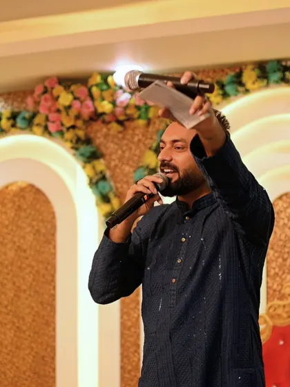 Holding up my notes while on the mic. Even in the most energetic moments, I stay organized to ensure the event flows perfectly according to plan.