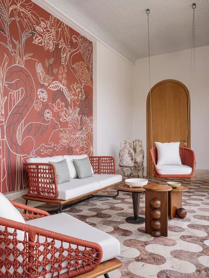 A vibrant, custom mural by House of Berserk adorns the first-floor terrace wall, creating a stunning backdrop for the outdoor seating area.