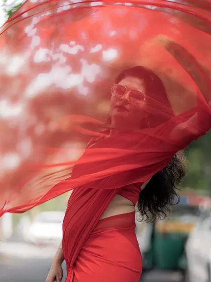 Style should be dynamic and expressive. I love playing with simple fabrics like this red georgette saree, using movement and a bold color to create a powerful and memorable fashion statement.
