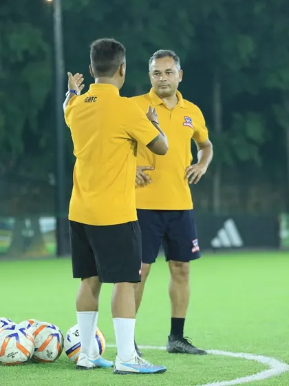 Two of our coaches discussing strategy during a training session.