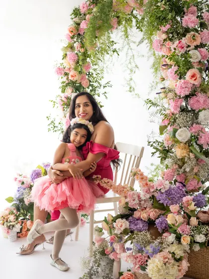 A mother and daughter dressed in pink, surrounded by a stunning floral arch. This was for my Mother's Day mini-sessions, designed to celebrate their special bond.