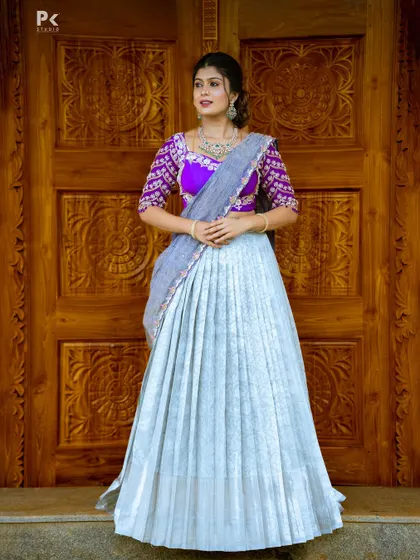A full view of the sky blue and purple half saree, a perfect choice for a modern and stylish look for any celebration.