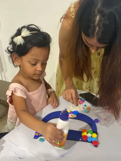 A mother guiding her daughter as she creates her own personalized monogram. These shared creative experiences are what make our studio so special.