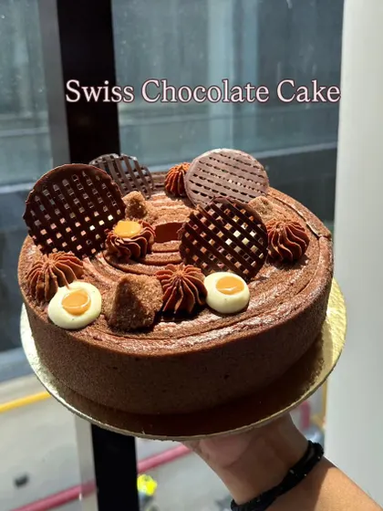 A classic Swiss Chocolate Cake, decorated with intricate chocolate work. Nothing beats the classics, especially when they are taught with such grace.
