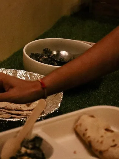A plate of food from the community cooking session of our 'Wild Food Walk', featuring roti and a sabji made from foraged greens.