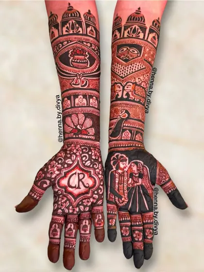 This stunning bridal mehendi includes a couple portrait and the initials 'CR'. The arms are decorated with royal motifs like palaces, peacocks, and kalash.