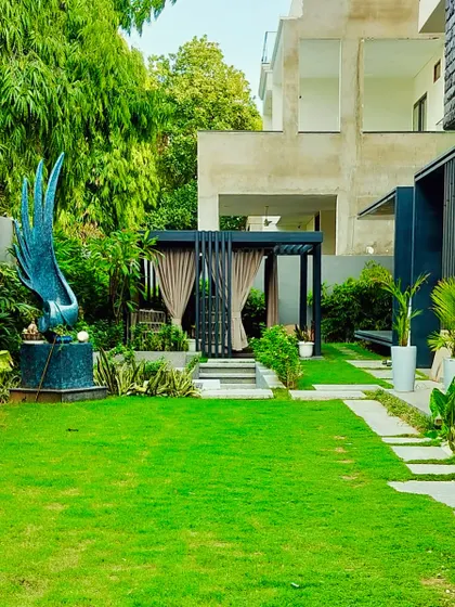 A closer look at the art sculpture and the path leading towards the private gazebo, showing how different elements are layered in the design.
