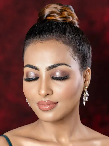 A serene shot with eyes closed, highlighting the blended, shimmery eyeshadow.