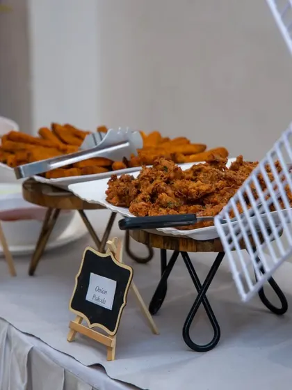 A platter of crispy onion pakodas, a classic Indian snack perfect for any party. We serve them hot and fresh, ensuring a savory treat for all guests.