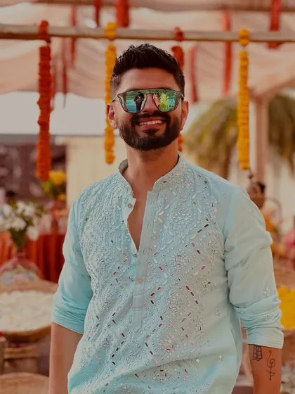 A close-up of the light blue kurta, showing off the mirror work and my happy smile.