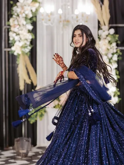 A dynamic pose from the bride's solo, showcasing her confidence and the intricate details of her sparkling outfit.