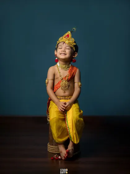A joyful little Krishna, his smile lighting up the studio. Our Janmashtami sessions capture the divine and playful spirit of the festival.