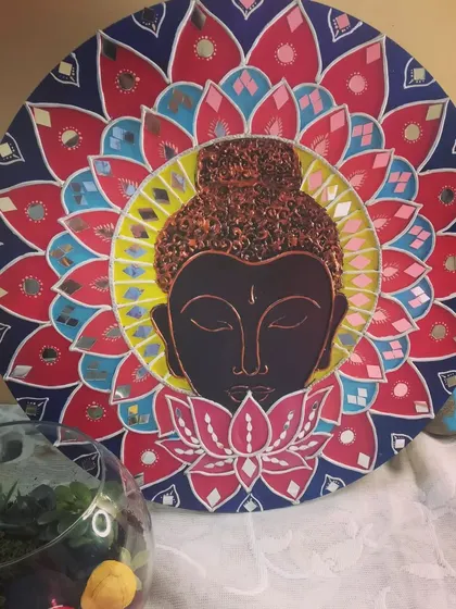 This Buddha Lippan art piece is designed to bring a sense of calm and serenity. The central Buddha figure is surrounded by a colorful lotus mandala with mirror accents.