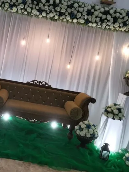 Another angle of the minimalist reception setup, highlighting the clean white and green color scheme.