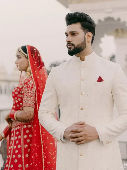 A portrait of the groom. Standing proud in his bespoke ivory sherwani, our client embodies the quiet confidence and regal charm that we strive to deliver with every garment.