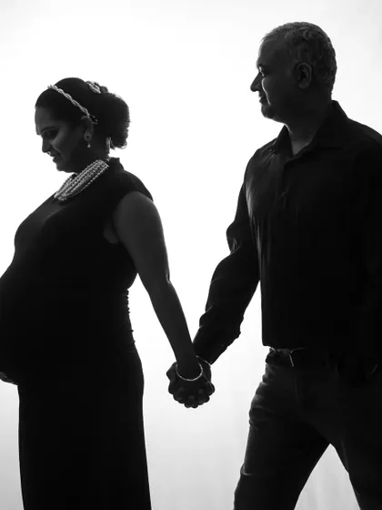 A dramatic black and white silhouette. This studio technique creates a powerful and artistic image, focusing on the form and connection of the couple.