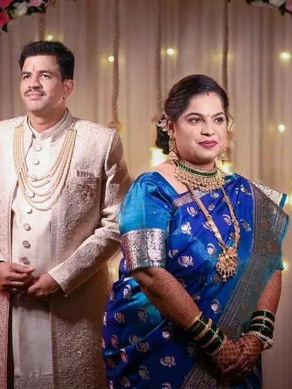 A formal portrait of the couple on their wedding stage. This shot captures their elegant attire and the beautifully decorated backdrop of their ceremony.
