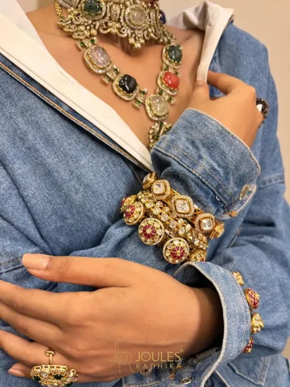 The art of the complete look. Here, the Navratna necklace is paired with matching bangles worn over a modern denim jacket, showcasing the versatility of our couture pieces.